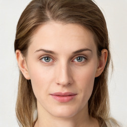 Joyful white young-adult female with long  brown hair and blue eyes