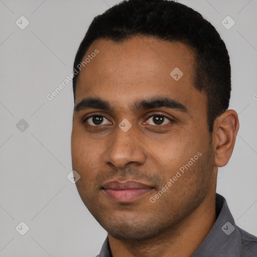 Joyful black young-adult male with short  black hair and brown eyes