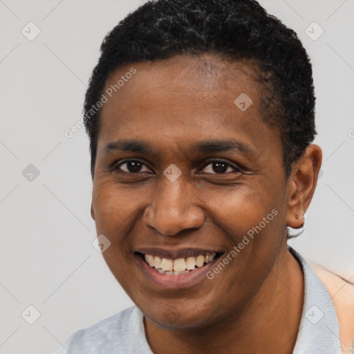 Joyful black young-adult male with short  black hair and brown eyes