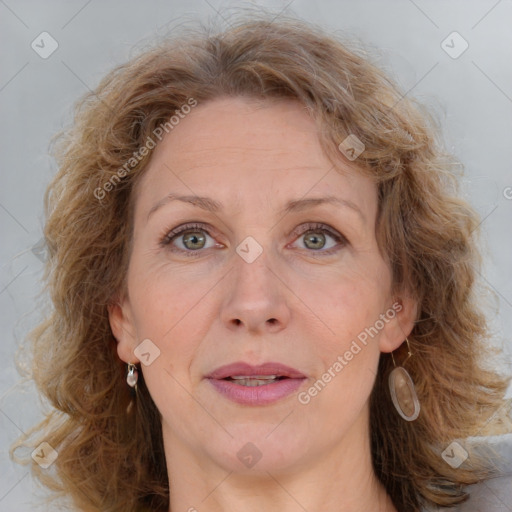 Joyful white adult female with medium  brown hair and blue eyes