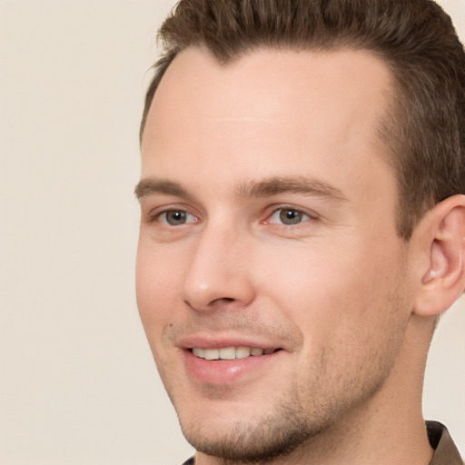 Joyful white young-adult male with short  brown hair and brown eyes