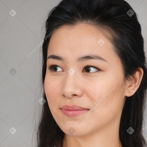 Joyful asian young-adult female with long  brown hair and brown eyes