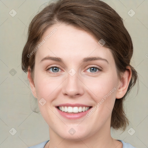 Joyful white young-adult female with medium  brown hair and green eyes