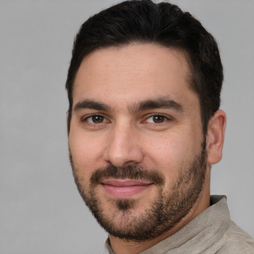 Joyful white young-adult male with short  black hair and brown eyes