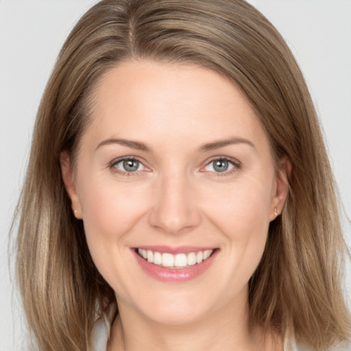 Joyful white young-adult female with long  brown hair and grey eyes