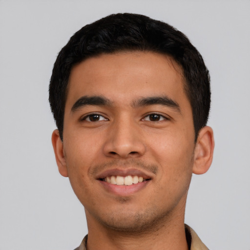 Joyful latino young-adult male with short  black hair and brown eyes