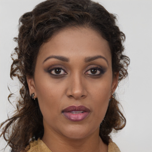 Joyful black young-adult female with medium  brown hair and brown eyes