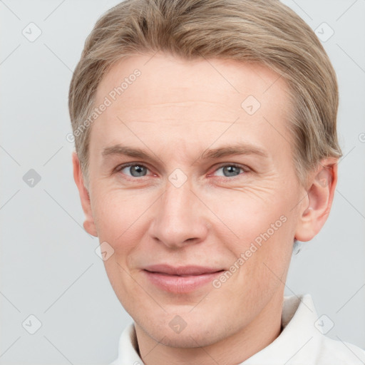 Joyful white adult male with short  brown hair and grey eyes