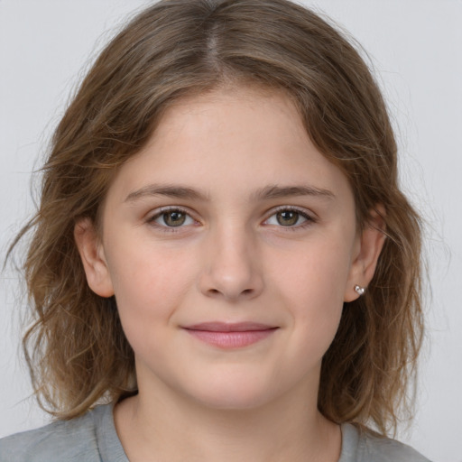 Joyful white child female with medium  brown hair and grey eyes