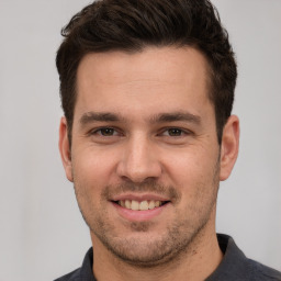 Joyful white young-adult male with short  brown hair and brown eyes