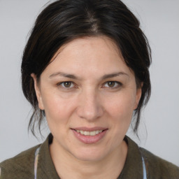 Joyful white adult female with medium  brown hair and brown eyes