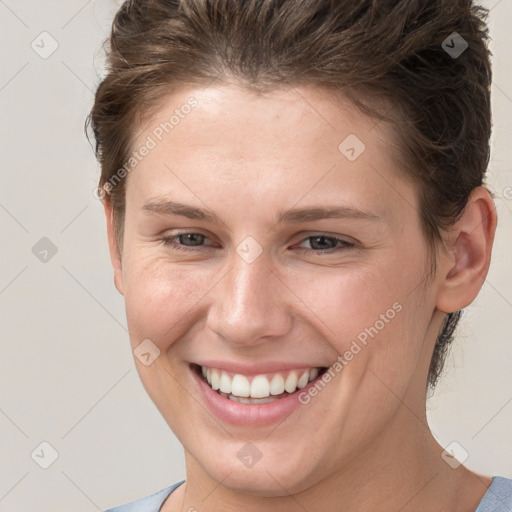 Joyful white young-adult female with short  brown hair and grey eyes