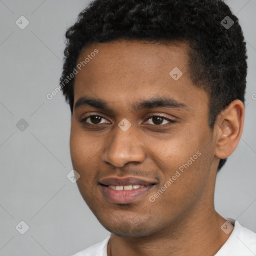 Joyful black young-adult male with short  black hair and brown eyes
