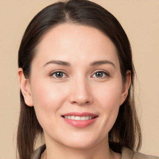 Joyful white young-adult female with long  brown hair and brown eyes