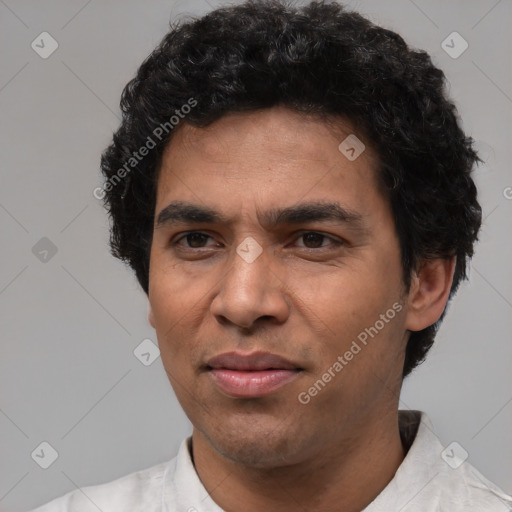 Joyful white adult male with short  black hair and brown eyes