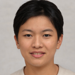 Joyful asian young-adult female with short  brown hair and brown eyes