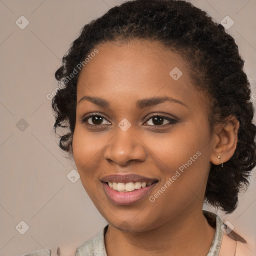 Joyful black young-adult female with medium  black hair and brown eyes