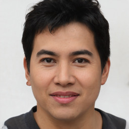 Joyful asian young-adult male with short  black hair and brown eyes