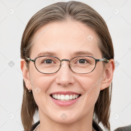 Joyful white adult female with medium  brown hair and blue eyes