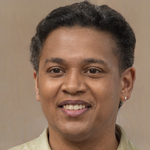 Joyful latino adult male with short  brown hair and brown eyes