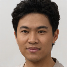 Joyful asian young-adult male with short  black hair and brown eyes