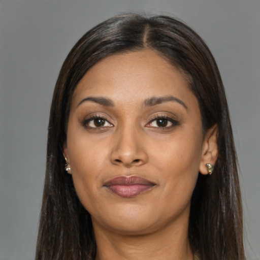 Joyful black young-adult female with long  brown hair and brown eyes