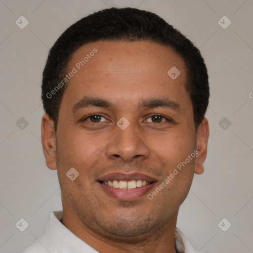 Joyful latino young-adult male with short  brown hair and brown eyes