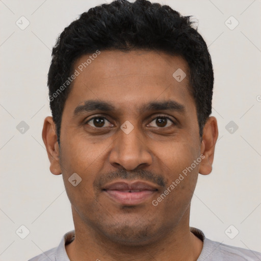 Joyful black young-adult male with short  black hair and brown eyes
