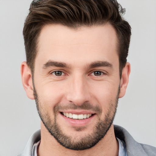 Joyful white young-adult male with short  brown hair and brown eyes