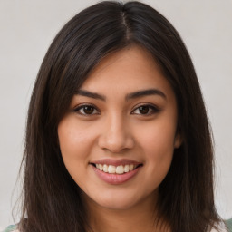 Joyful latino young-adult female with long  brown hair and brown eyes