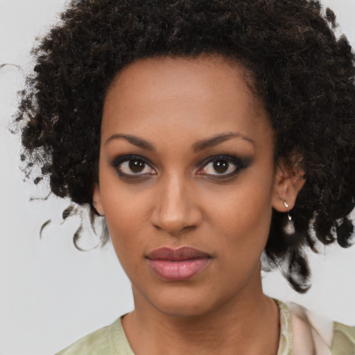 Joyful black young-adult female with medium  brown hair and brown eyes
