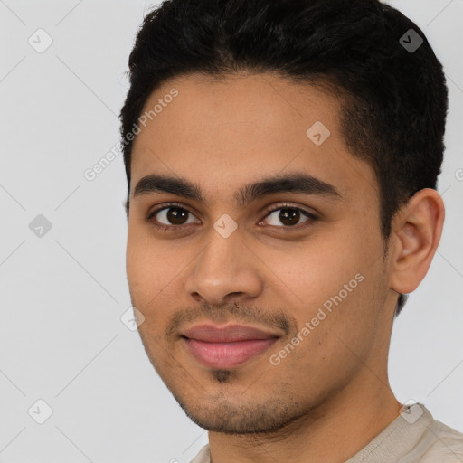 Joyful latino young-adult male with short  black hair and brown eyes