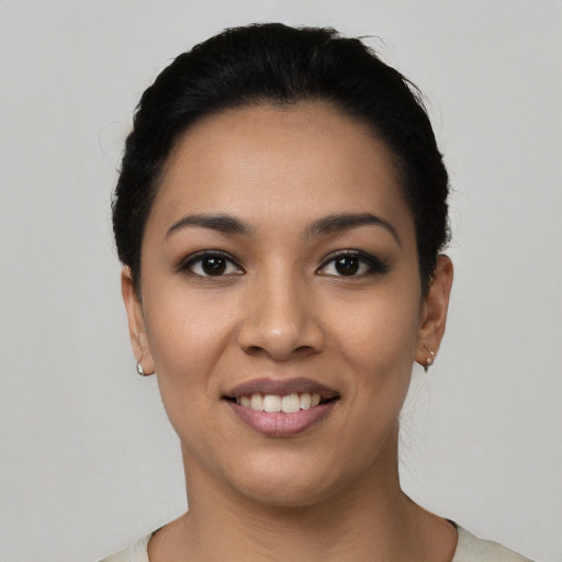 Joyful latino young-adult female with short  black hair and brown eyes