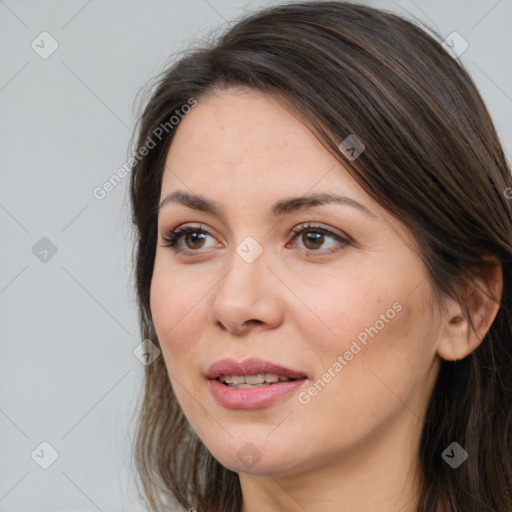 Joyful white adult female with long  brown hair and brown eyes