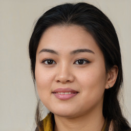 Joyful asian young-adult female with long  brown hair and brown eyes