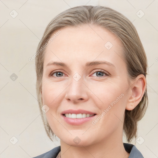 Joyful white young-adult female with medium  brown hair and blue eyes