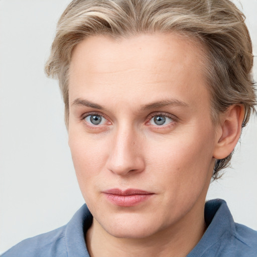 Joyful white young-adult female with short  brown hair and blue eyes