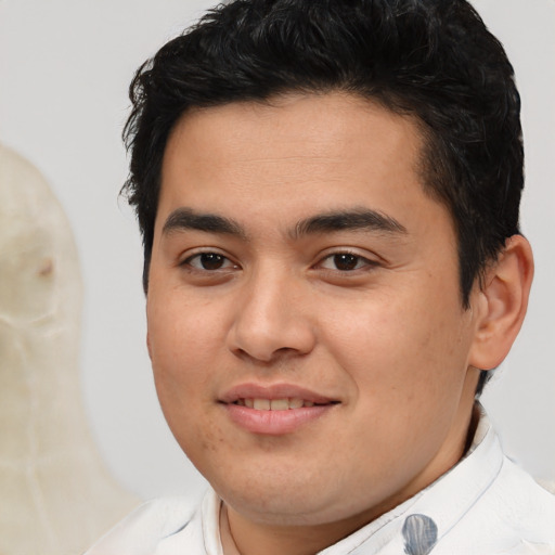Joyful latino young-adult male with short  brown hair and brown eyes