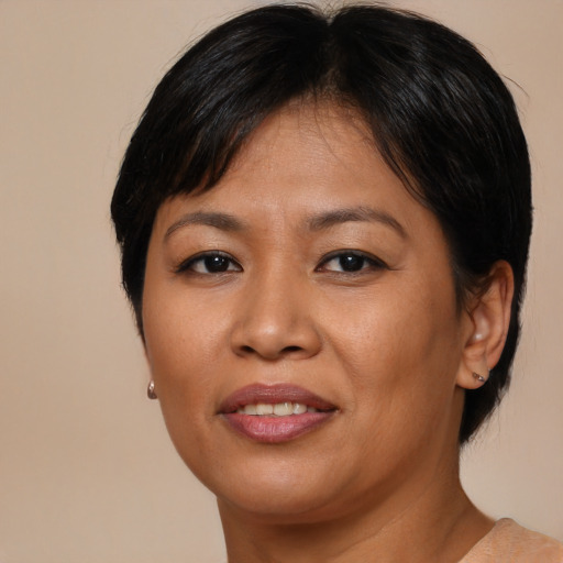 Joyful asian adult female with medium  brown hair and brown eyes