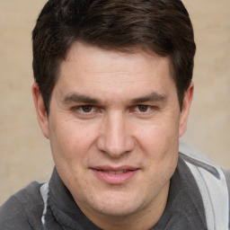 Joyful white adult male with short  brown hair and brown eyes