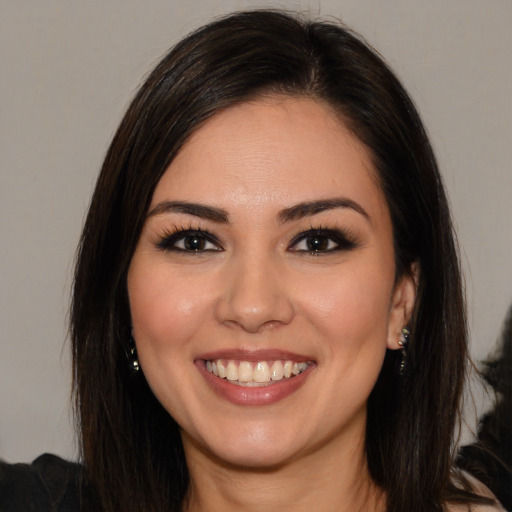 Joyful white young-adult female with long  brown hair and brown eyes