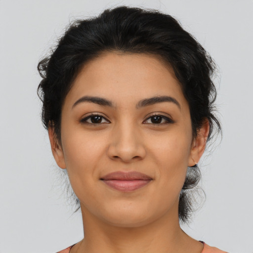 Joyful latino young-adult female with medium  brown hair and brown eyes