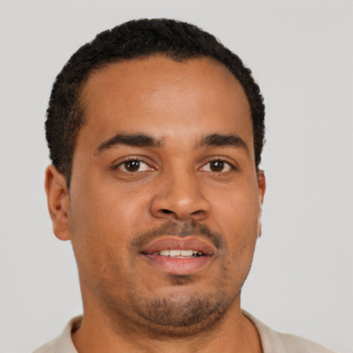 Joyful latino young-adult male with short  brown hair and brown eyes