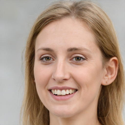 Joyful white young-adult female with long  brown hair and green eyes