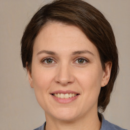 Joyful white adult female with medium  brown hair and brown eyes