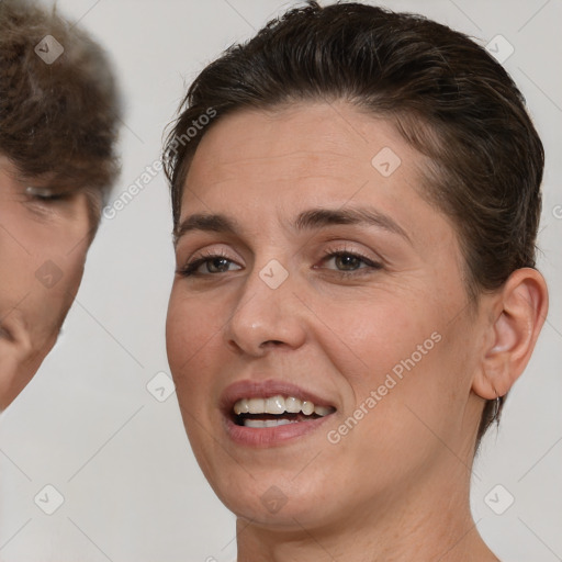 Joyful white adult female with medium  brown hair and brown eyes