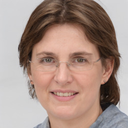 Joyful white adult female with medium  brown hair and grey eyes