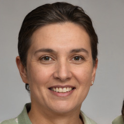 Joyful white adult female with medium  brown hair and brown eyes