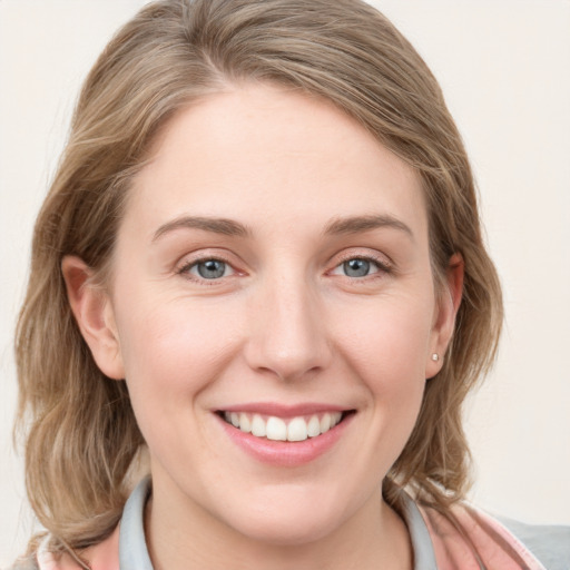 Joyful white young-adult female with medium  brown hair and blue eyes