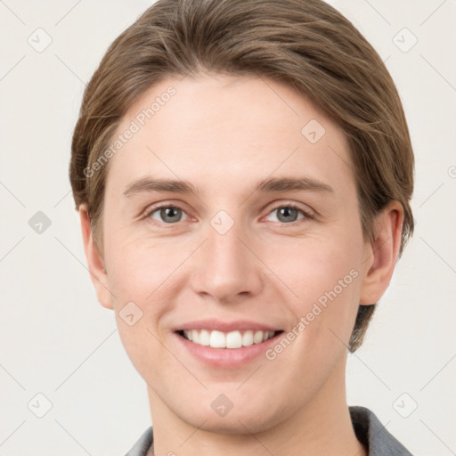 Joyful white young-adult female with short  brown hair and grey eyes